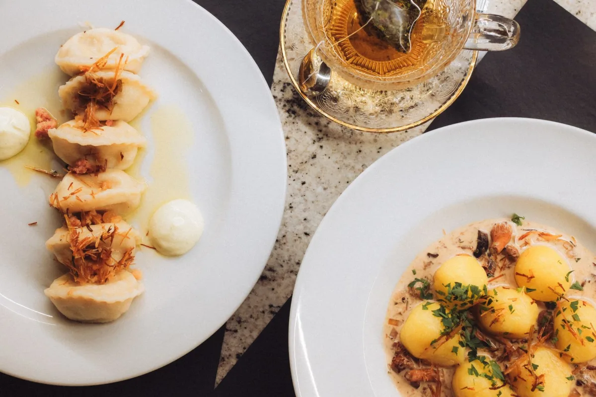 Traditional Polish food — pierogi and potatoes in a mushroom sauce